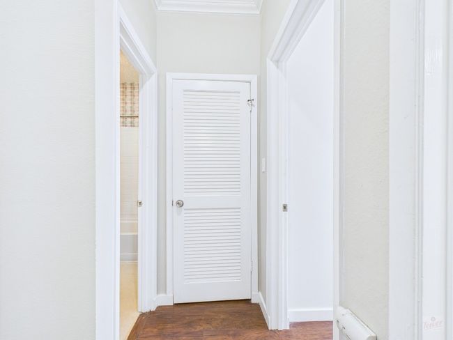 Corridor with dark wood-type flooring and baseboards | Image 27