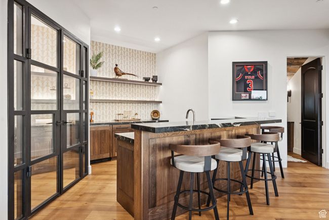 Indoor wet bar featuring wallpapered walls, light wood-style flooring, recessed lighting, and an accent wall | Image 51