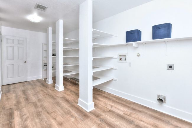 This enormous pantry and utility room combination is perfectly situated between the garage and kitchen | Image 17