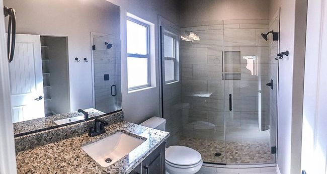 Full bathroom featuring a shower stall, a wealth of natural light, toilet, and vanity | Image 19