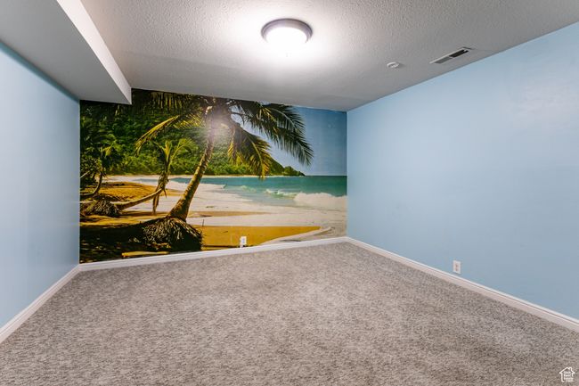 Spare room with carpet, baseboards, and a textured ceiling | Image 26