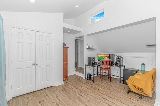 Sitting room featuring lofted ceiling, wood finished floors, a desk, and recessed lighting | Image 25