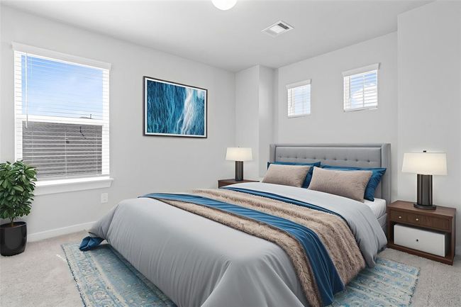 Secondary bedroom features plush carpet, custom paint, lighting, closet space, windows with privacy blinds, and private access to a secondary bathroom | Image 14