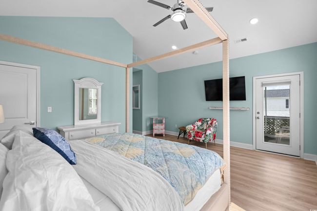 Bedroom featuring visible vents, recessed lighting, wood finished floors, lofted ceiling, and baseboards | Image 19