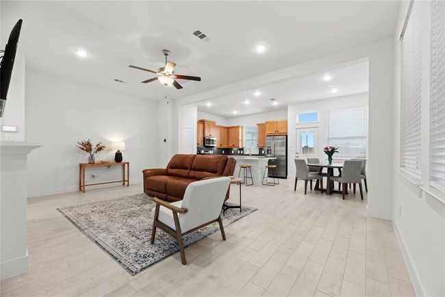 Nice, open floor plan. Neutral paint color and gorgeous wood-look tile flooring. | Image 6