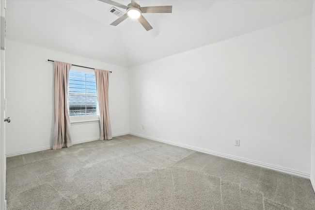 Empty room featuring carpet, a ceiling fan, and lofted ceiling | Image 28