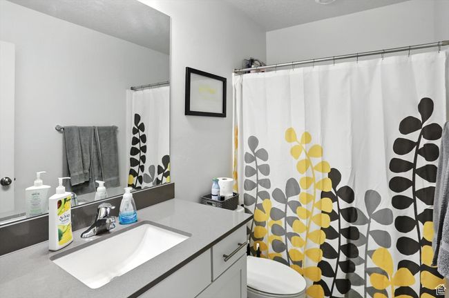 Bathroom with vanity and a shower with curtain | Image 16