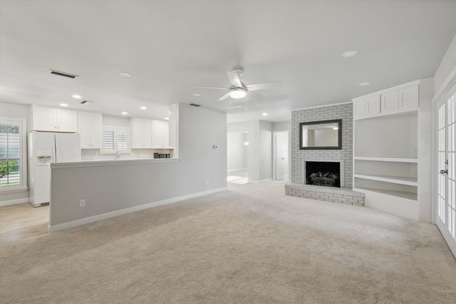 Unfurnished living room with light carpet, baseboards, visible vents, recessed lighting, and ceiling fan | Image 15