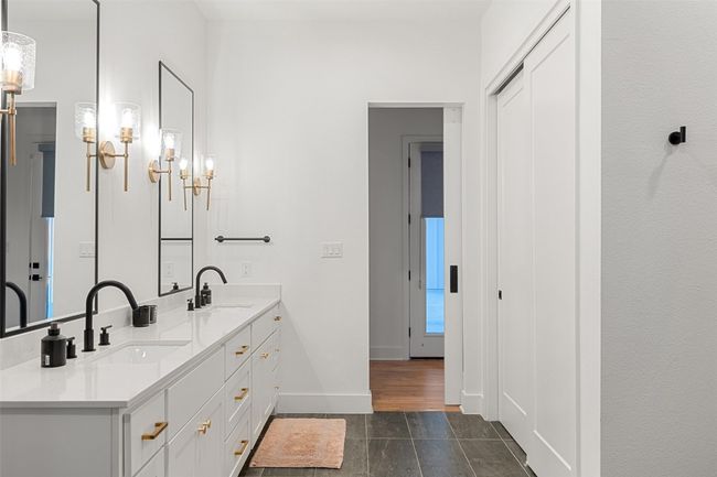 Full bathroom featuring double vanity and a chandelier | Image 23