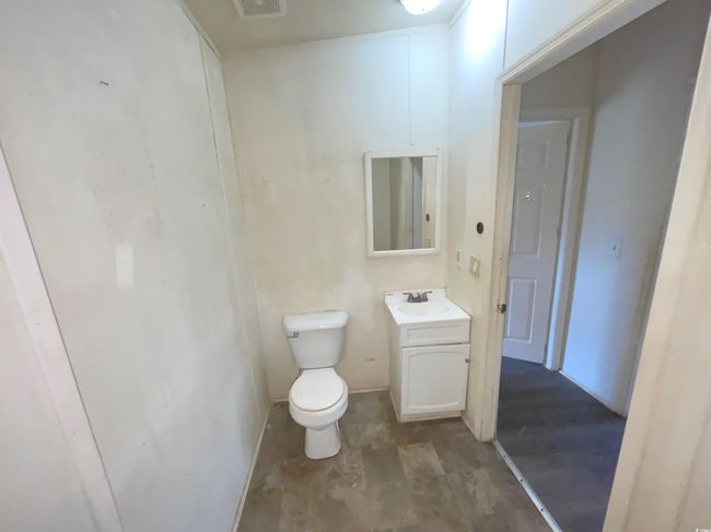 Half bathroom featuring vanity, visible vents, and toilet | Image 12