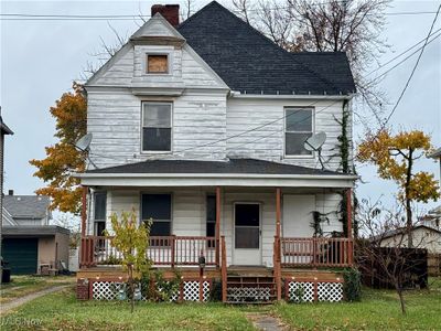 View of front of property featuring covered porch and a front yard | Image 2