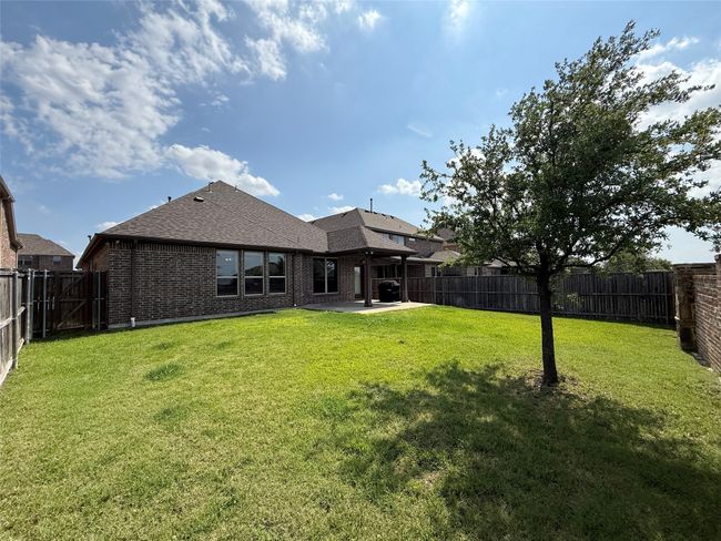 Back of property with a patio, brick siding, and a shingled roof | Image 17