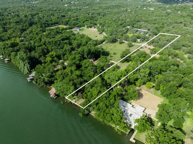 Aerial view of property and surrounding area with a nearby body of water and property parcel outlined | Image 19