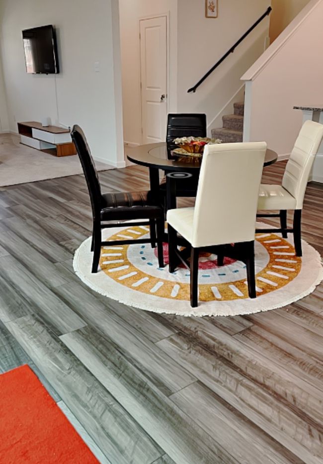 Dining room featuring wood finished floors and stairs | Image 5