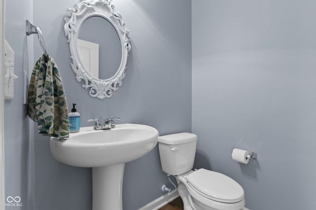 Half bathroom with toilet and baseboards | Image 5