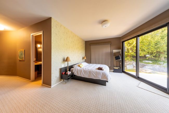 Carpeted bedroom featuring baseboards, access to outside, and connected bathroom | Image 28