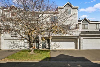 Welcome to 1061 108th Lane! This townhome features a huge south-facing deck above the garage along with a large window letting in all the sunshine! | Image 1