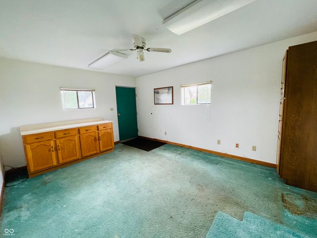 spare room with plenty of natural light, light colored carpet, and a ceiling fan | Image 4
