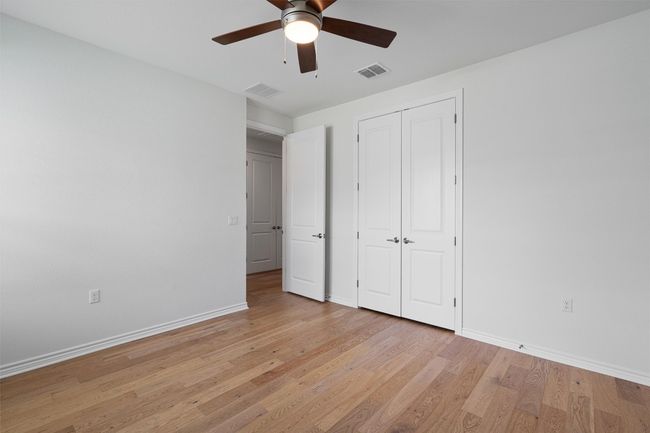 Second bedroom with closet near the half and full baths. This home has 2 full baths plus a half bath. | Image 18