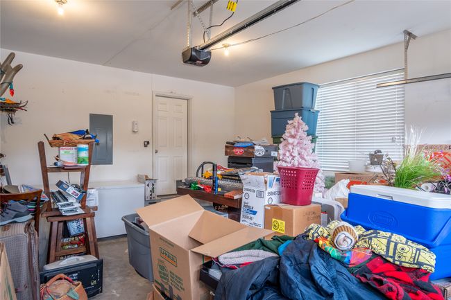 Garage with electric panel and a garage door opener | Image 54