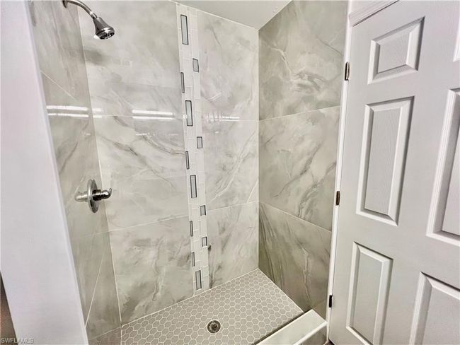 Primary Bathroom featuring a newly tiled shower. | Image 22