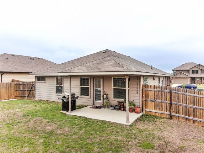 Rear view of property with a patio area, a fenced backyard, and a lawn | Image 23