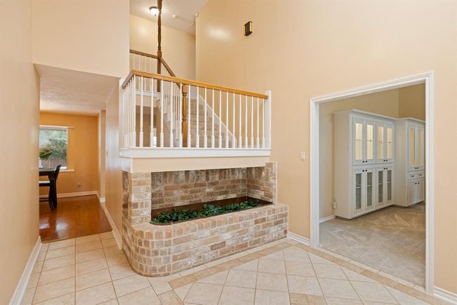 Step inside this spacious, soaring 2-story entryway with a unique built-in planter and bright, welcoming skylight | Image 7