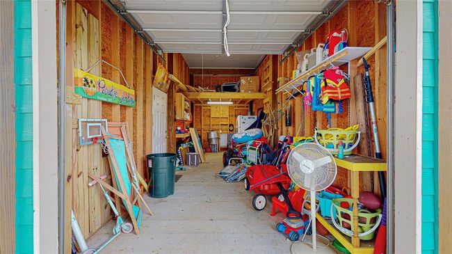 Spacious garage with plenty of storage, perfect for all your beach supplies, golf cart, or anything else you need to make the most of your coastal lifestyle. Everything you see here, is included with the sale. Extra refrigerator for all food and drinks! Home screens for windows located in the loft. | Image 5