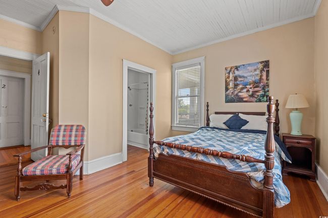 Bedroom with light wood-style flooring and crown molding | Image 30
