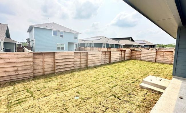Fenced backyard with a residential view | Image 9
