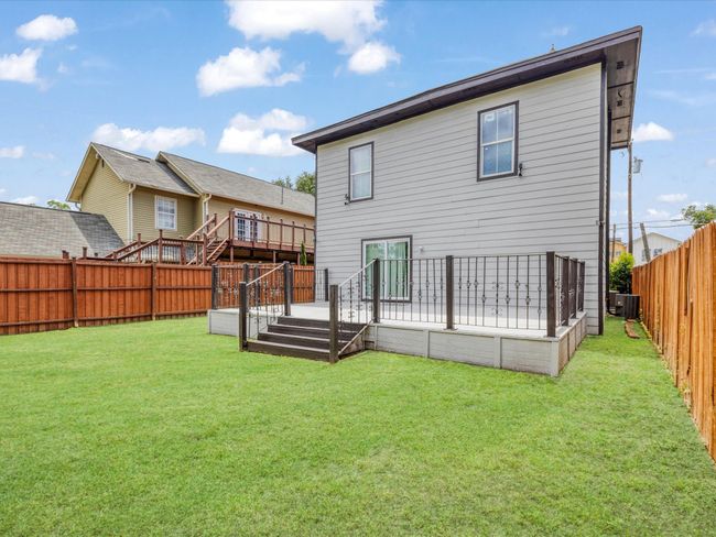Rear view of house with central AC and a wooden deck | Image 31