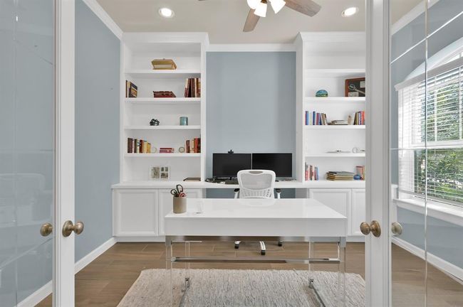 At the front of the home you'll find your relaxed home office, with efficient built-in cabinetry and abundant natural light accessible through beautiful etched glass French doors. Plenty of space for two work stations. | Image 5