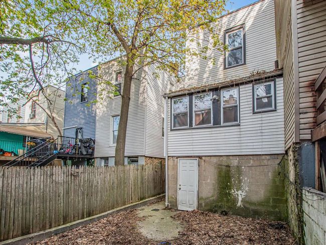 Rear view of house with fence and stairs | Image 22