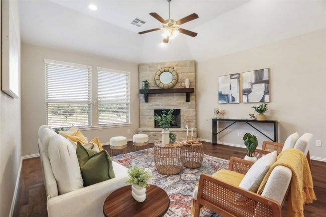 Family room with fireplace and views of neighborhood pond | Image 9