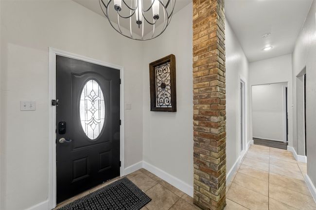 Entryway featuring a chandelier, baseboards, and light tile patterned floors | Image 28