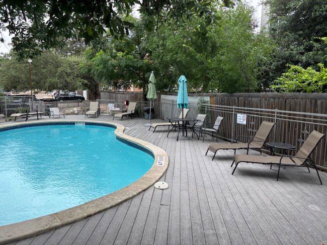 Community pool featuring a wooden deck and a fenced backyard | Image 6