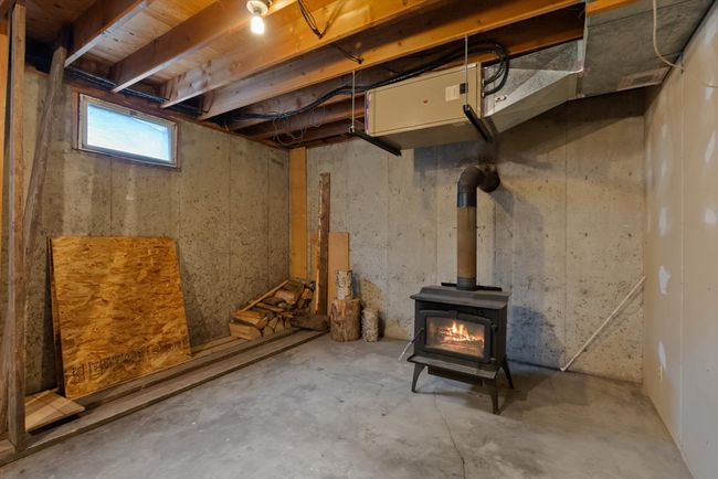 Below grade area with a wood stove | Image 18