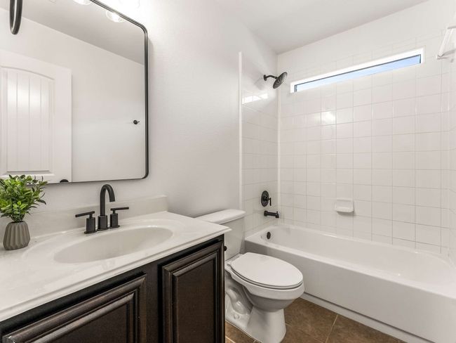 Bathroom with vanity, shower / washtub combination, and tile patterned floors | Image 25