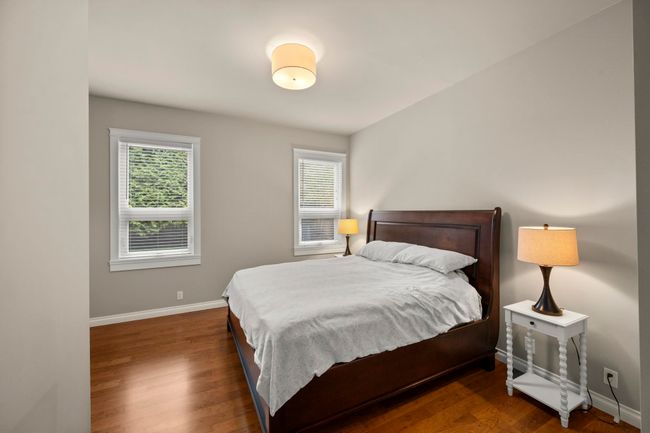 Bedroom with wood finished floors, baseboards, and multiple windows | Image 20
