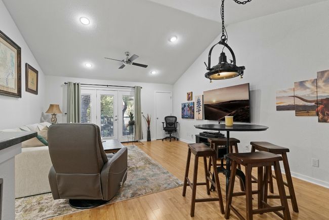 Living area with lofted ceiling, ceiling fan, wood finished floors, baseboards, and recessed lighting | Image 4