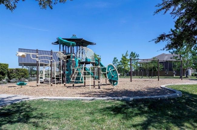 The community playground features climbing structures, slides, and swings. | Image 36