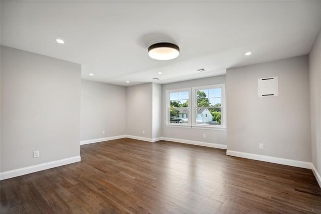 Empty room featuring recessed lighting and dark wood-style flooring | Image 19