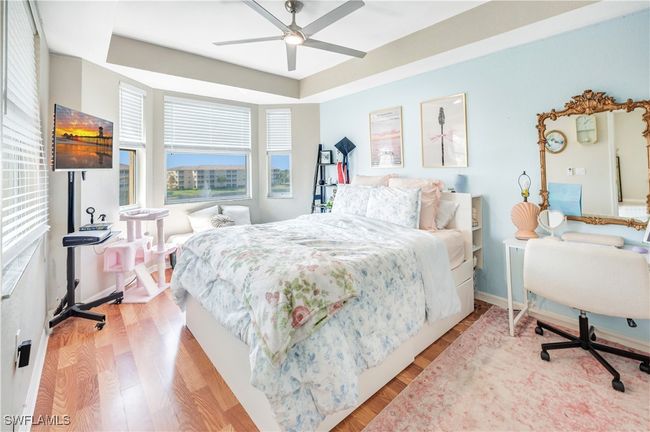 Bedroom with light hardwood / wood-style flooring and ceiling fan | Image 12