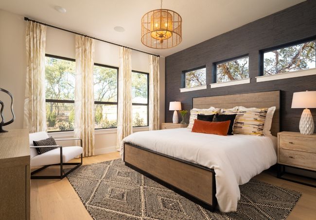 Bedroom with wood finished floors, an accent wall, and wallpapered walls | Image 7