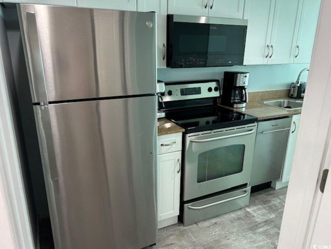 Kitchen featuring stainless steel appliances and a sink | Image 8