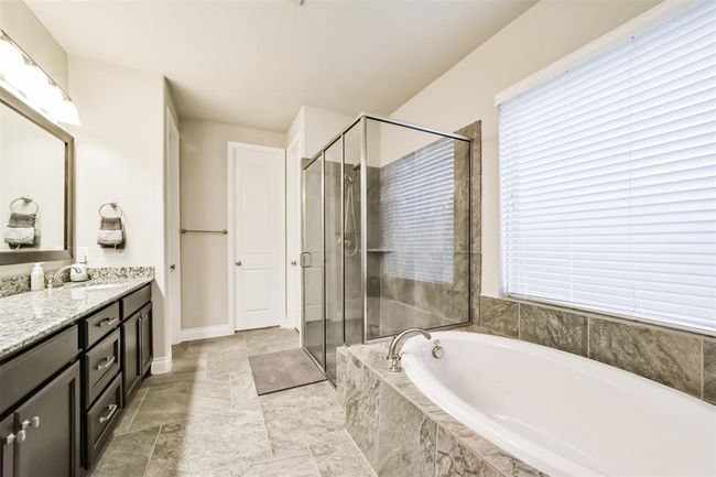 Secondary view of the primary bathroom. Soaking tub and large separate shower compliment the space. Whether you're getting ready for the day or winding down at night you have both comfort and sophistication making it a true retreat. | Image 15