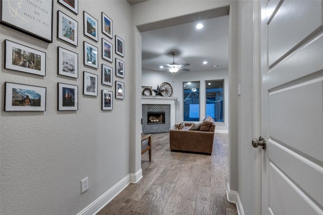 Hallway with baseboards, recessed lighting, and dark wood-type flooring | Image 10