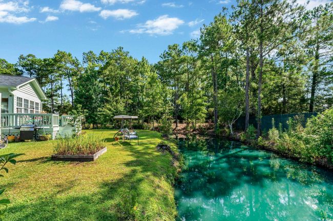 Rear view of house with a lawn and a deck | Image 22