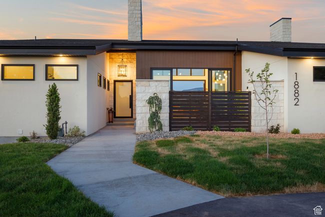 View of front of property with a chimney, a yard, and stucco siding | Image 6
