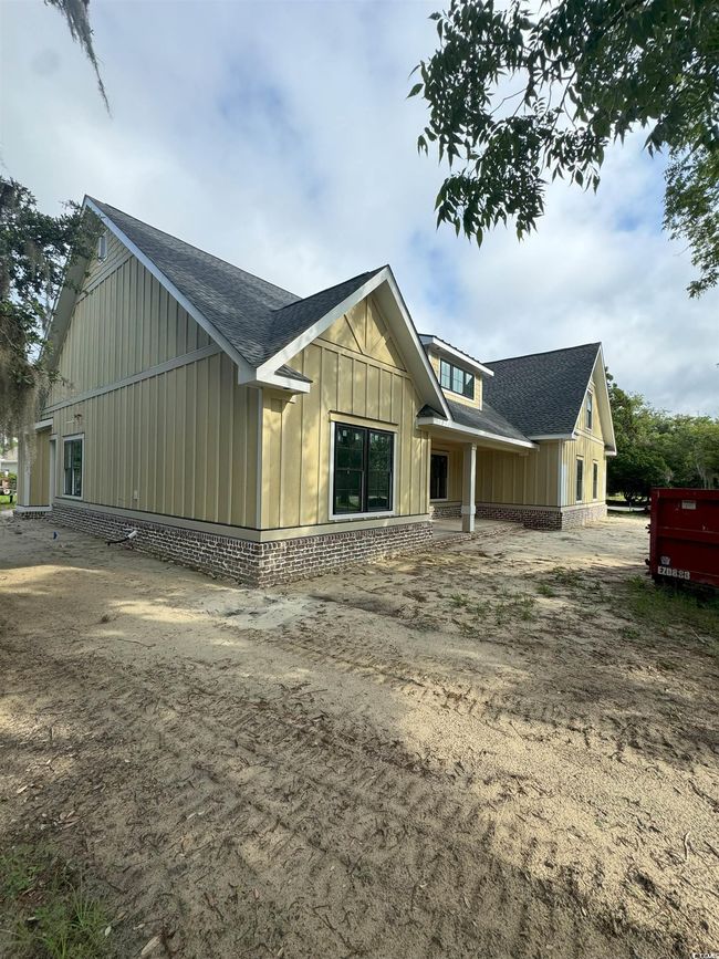 View of side of property with board and batten siding and a shingled roof | Image 18